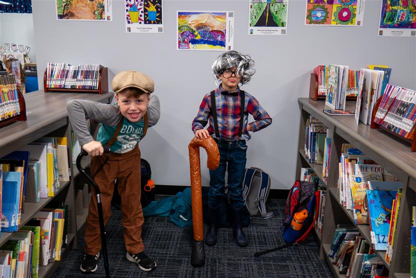 two boys with canes in the library